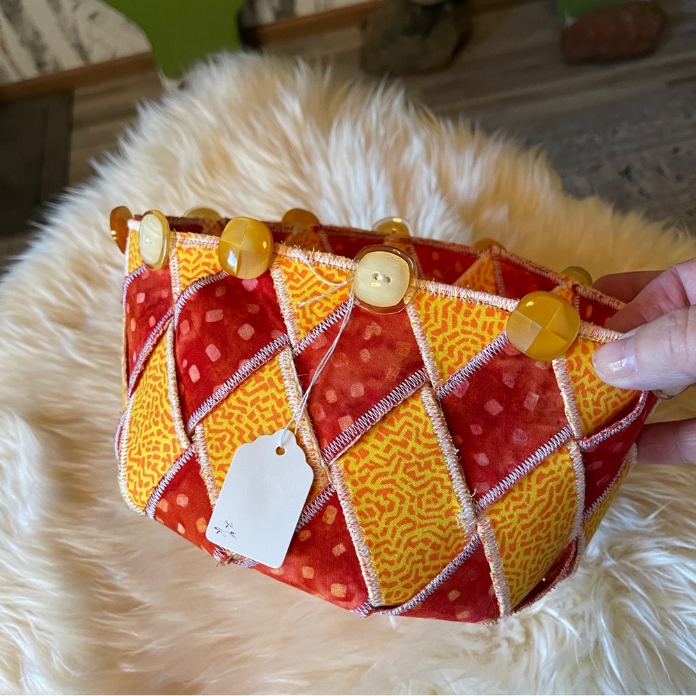 Handcrafted fabric basket. "Woven Spirals" Orange & Yellow Measures 8.5” dia